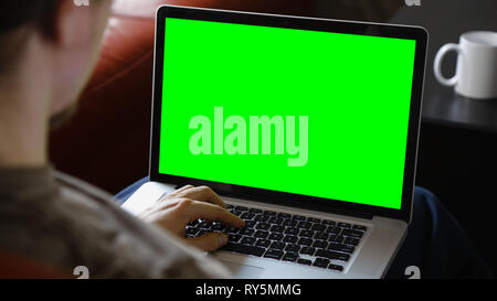 Man Sitting Using Blank Laptop Computer Stock Photo