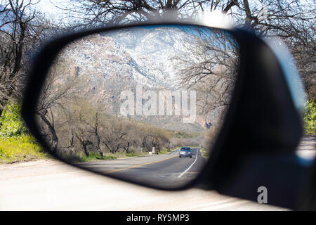 Scenic reflections in a side view mirror from inside a car. Catalina State Park, Tucson, Arizona Stock Photo