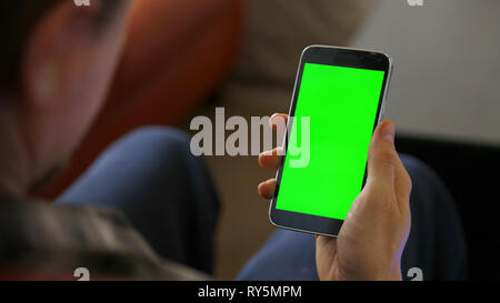 Man Sitting Using Blank Smart Phone Stock Photo