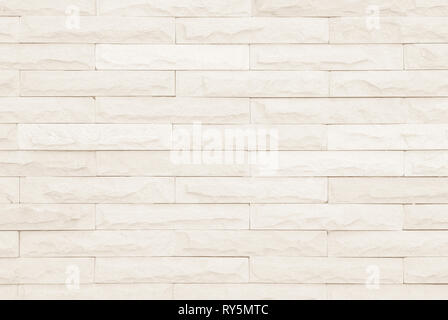 Cream and white brick wall texture background. Brickwork or stonework flooring interior rock old pattern clean concrete grid uneven bricks design stac Stock Photo