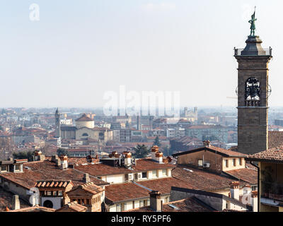 Travel to Italy - above view of Citta Bassa (Lower Town) of Bergamo city with bell tower is spring haze Stock Photo