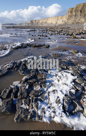 Sea foam on the shoreline at Monknash on the Glamorgan Heritage Coast ...