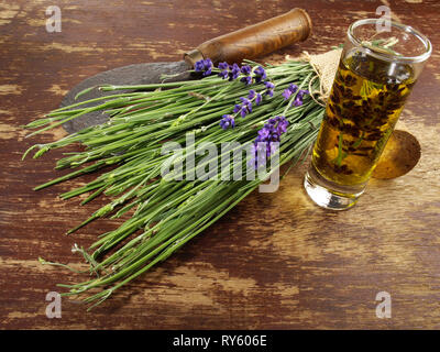 Fresh Lavender and Oil on wooden Background Stock Photo