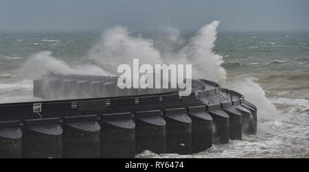 Brighton, UK. 12th Mar, 2019. Waves crash over Brighton Marina western wall this morning as Storm Gareth starts to batter Britain and Ireland with winds expected to reach over 70mph in some areas Credit: Simon Dack/Alamy Live News Stock Photo