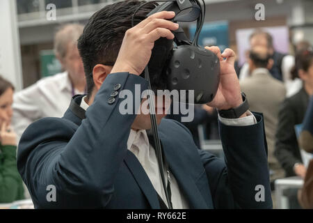 London, UK. 12th March 2019. A vistor tries out a VR Headset at The Wearable Technology Show at the Business Design Centre, The largest dedicated event for connected technology, the show features innovative products from start-ups as well as products from major technology companies and includes the latest in virtual reality and augmented reality devices and software Credit: Ian Davidson/Alamy Live News Stock Photo