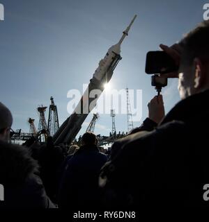 Baikonur, Kazakhstan. 12th Mar, 2019. The Russian Soyuz MS-12 rocket is raised to a vertical position on the launch pad at the Baikonur Cosmodrome March 12, 2019 in Baikonur, Kazakhstan. The Expedition 59 crew: Nick Hague and Christina Koch of NASA and Alexey Ovchinin of Roscosmos will launch March 14th for a six-and-a-half month mission on the International Space Station. Credit: Planetpix/Alamy Live News Stock Photo