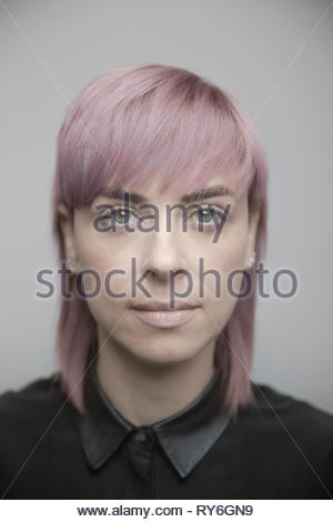 Portrait confident beautiful non-binary gender person with pink hair