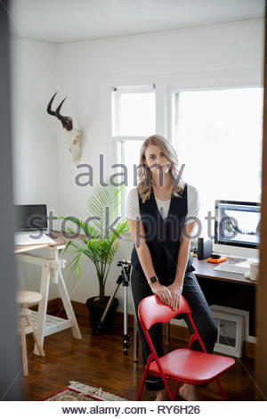 Portrait confident woman working in home office