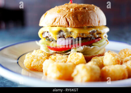 Close-up of burger with chicken nuggets served in plate on table Stock Photo