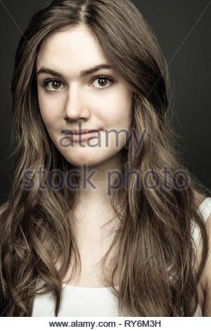 Portrait confident beautiful teenage girl with long hair and brown eyes