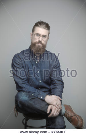 Portrait confident handsome young hipster man