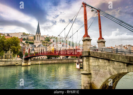 Pedestrian Saint Georges footbridge and the Saint Georges church in Lyon, France Stock Photo