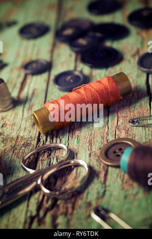 High angle view of various sewing items on old wooden table Stock Photo