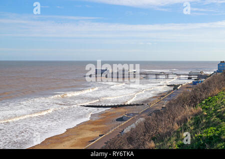 A view of the beach and pier with a moderate sea in winter on the North Norfolk coast at Cromer, Norfolk, England, United Kingdom, Europe. Stock Photo