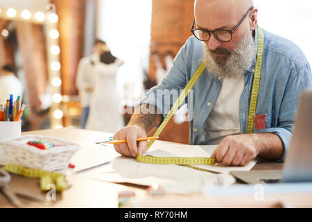 Tailor with measuring tape Stock Photo