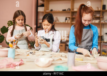 Three Girls in Pottery Workshop Stock Photo