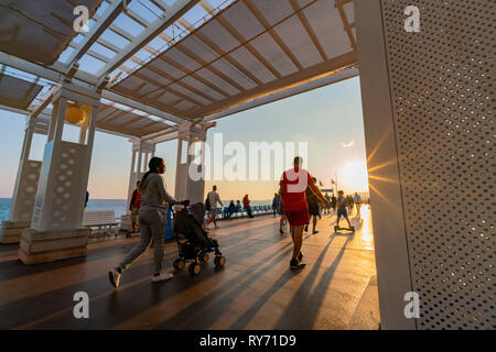 Nice, OCT 20: Sunset view of the beautiful Nice beach with many visitor walking around on OCT 20, 2018 at Nice, France Stock Photo