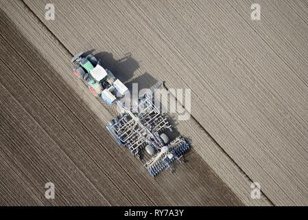 Modern agriculture, tractor working arable land in a field, Schleswig-Holstein, Germany Stock Photo