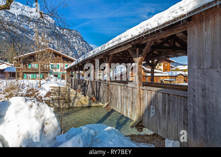 Wooden bridge over Loisach river in Garmisch Partenkirchen in winter Stock Photo