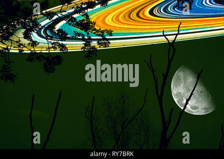 half moon and saturn ring back on silhouette dry tree and night sky ,Elements of this image furnished by NASA Stock Photo