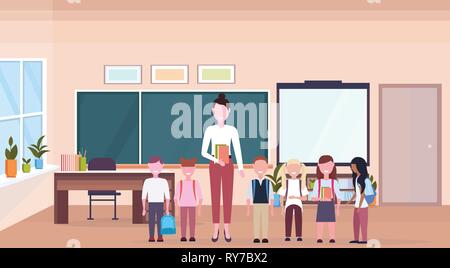woman teacher with mix race pupils standing in modern school classroom interior chalk board desk cartoon characters full length horizontal banner flat Stock Vector