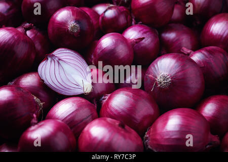 Full Frame Shot Of Purple Onions. Fresh whole purple onions and one sliced onion. Stock Photo