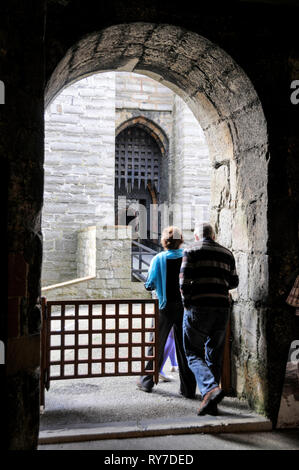 Visitors arriving at the main gated entrance to the 12th/13th century medieval built Castle Rushen in the centre of Castletown on the south coast of t Stock Photo