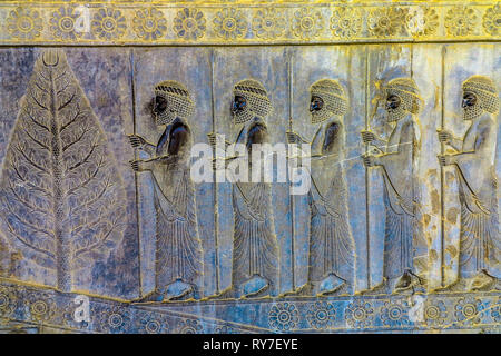 Persepolis Historical Site Wall Carving of Ancient Persian Soldiers and a Tree Stock Photo