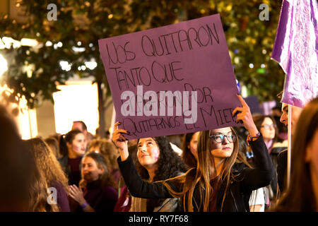 CORDOBA, SPAIN - 03, 08, 2019: Young woman carrying a banner at the Women's Day demonstration. Stock Photo