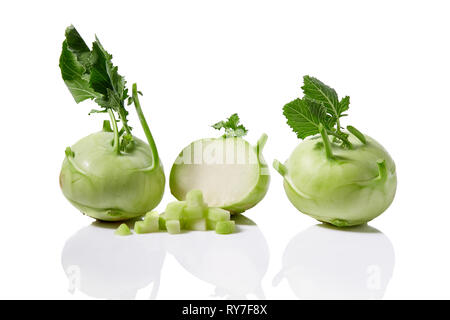 Fresh kohlrabi with with leafy stems still attached on white background Stock Photo