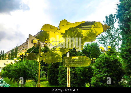 Kyrgyzstan Map Outline Golden Colored Made of Brazen in a Public Park Stock Photo