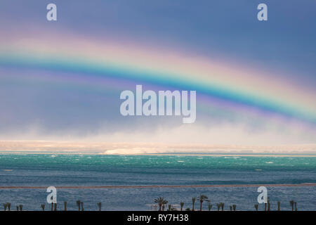 Rainbow over the turquoise waters of the Dead Sea. Skyscape Stock Photo