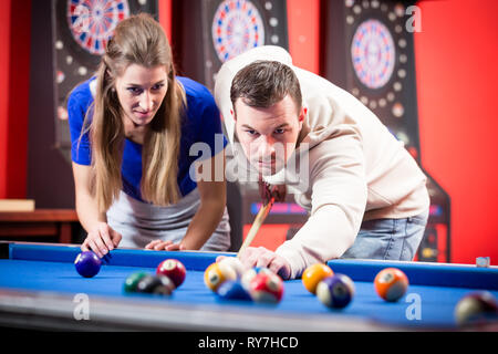 Young couple playing billiard Stock Photo