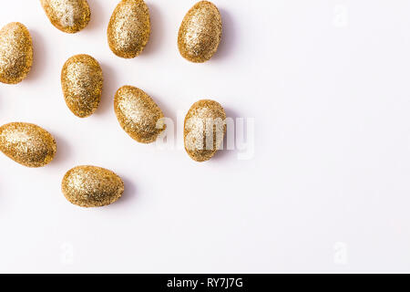Gold glitter easter eggs on a plain white background Stock Photo