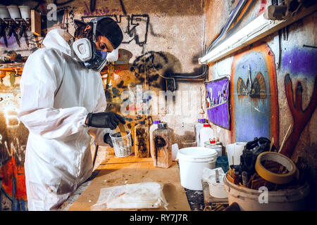 Master painter in a factory - industrial painting wood with spray gun. Stock Photo