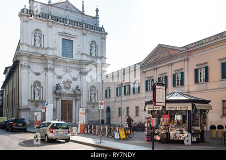 BRESCIA, ITALY - FEBRUARY 21, 2019: people near newsstand on square Piazza Arturo Benedetti Michelangeli near Conservatory and Auditorium in church Sa Stock Photo