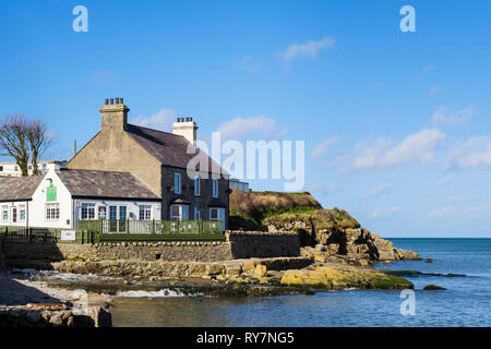 Bay Cafe and coastal footpath on rocky coast overlooking the sea. Benllech, Isle of Anglesey, North Wales, UK, Britain, Europe Stock Photo