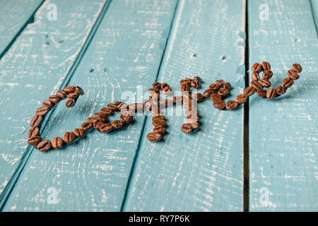 Coffee spelt with coffee beans on a weathered table Stock Photo