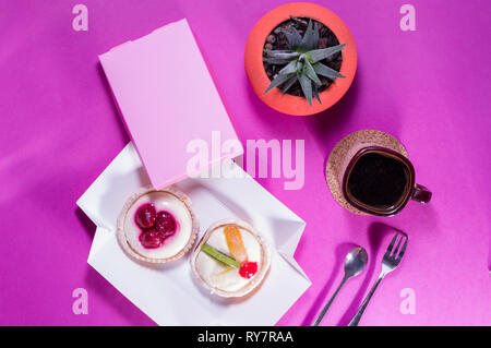 Mug of coffee and sweets. Cream cakes. Top view. Stock Photo