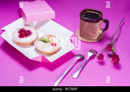 Coffee with sweets. Mug and cakes. Dessert appliances. Front view on the table. Stock Photo