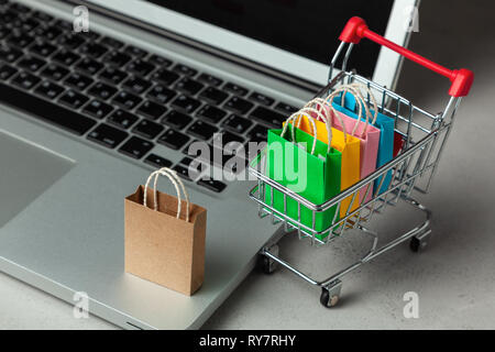Bag with  logo and shopping cart on a laptop keyboard