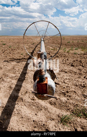 Sprinkler wheel line in dry fallow field in south-central Idaho Stock Photo