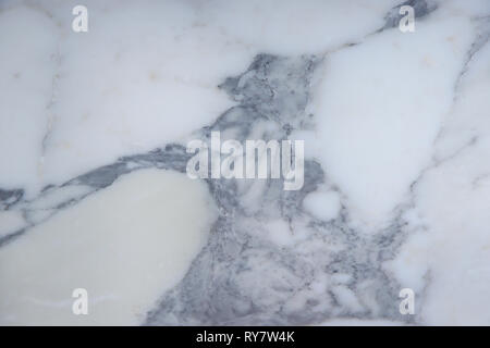 The beautiful surface of natural stone, light marble with a large gray pattern, is called Arabescato. Stock Photo