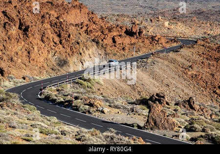 Car driving in the middle of Teide volcano lava fields Stock Photo