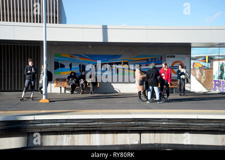 London. Hackney. Passengers wait on the platform at Hackney Wick station for an Overground train. Stock Photo