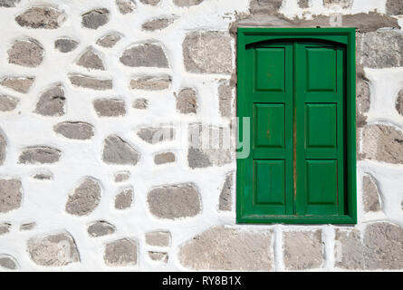 architectural background with typical Canary Isands house extrenal wall and a green window Stock Photo