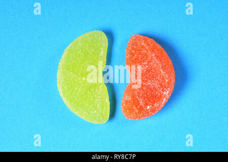orange and lemon jelly candy on blue background Stock Photo