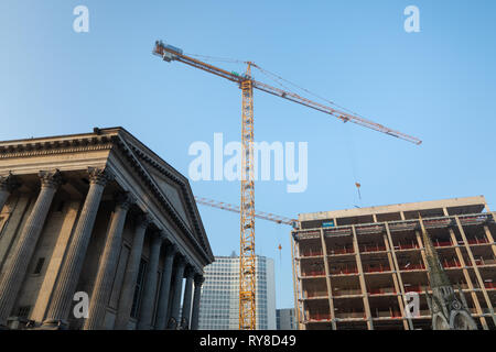 Birmingham, West Midlands / UK - February 24th 2019: Tower crane standing in Centenary Square between the City Hall and a building under construction. Stock Photo