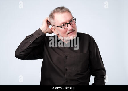 european man in black shirt and glasses thinking about his problems. Stock Photo