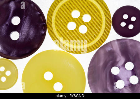 close up of yellow and purple buttons, photographed from above Stock Photo